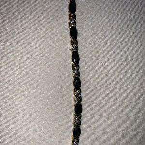 Black onyx and diamond 14 karat gold bracelet.